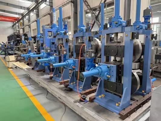 Close view of pipe mill forming stands and horizontal roll shafts